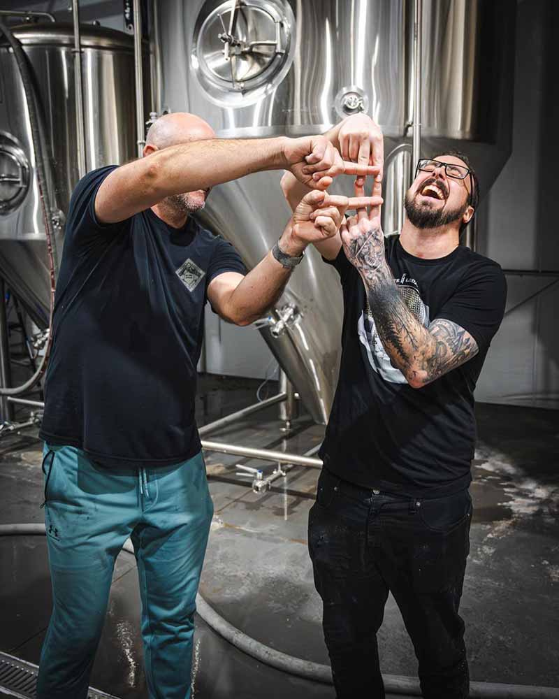 Corporate Ladder Brewing Company founders Blake Kleppe and James Herrholz posed for a photo in their production room