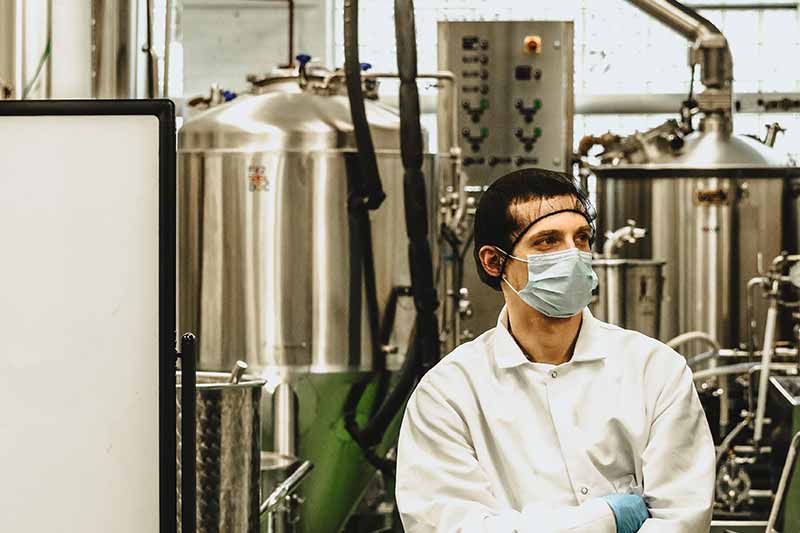 A person in inside of a craft brewery