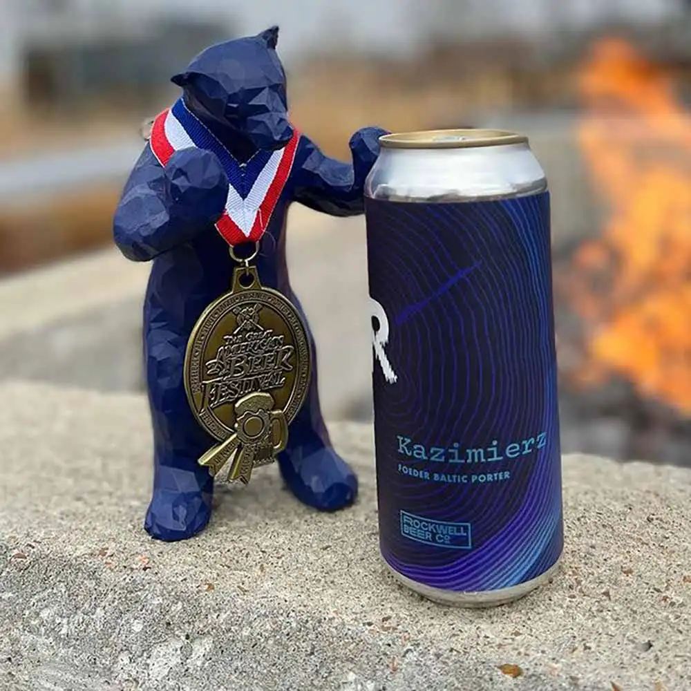 A photo of Kazimierz, a Baltic Porter craft beer from Rockwell Beer Co. with a Great American Beer Festival medal