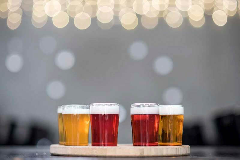 A flight of craft beers varying in colors all made using different fruit purees from Oregon Fruit Products