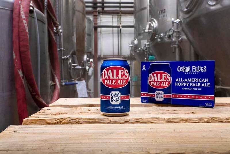A can and a six pack of Dale's Pale Ale from Oska Blues Brewery in the back of house brewhouse