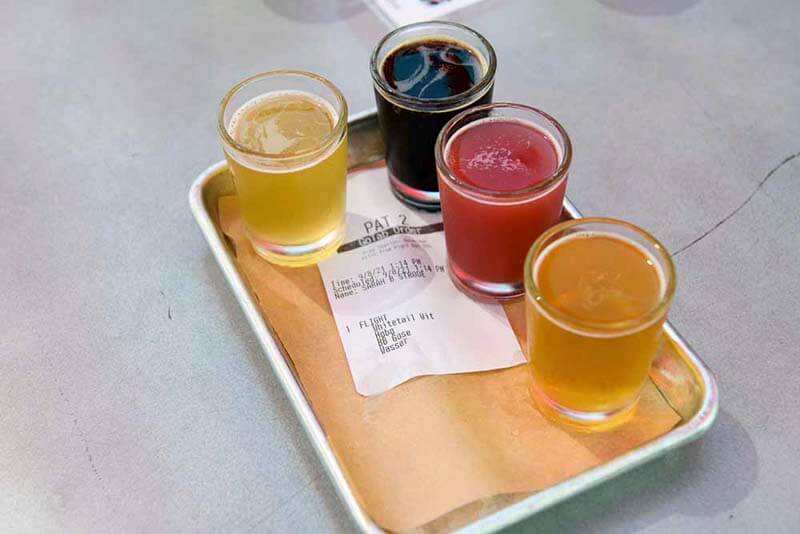 A flight of craft beers ordered from a QR code menu at a craft brewery