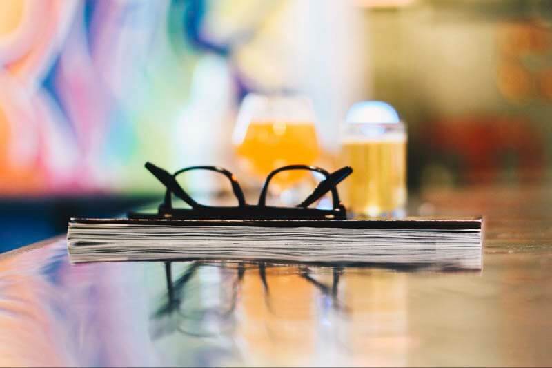 Accounting book with glasses on a bar at a craft brewery with beer in glasses