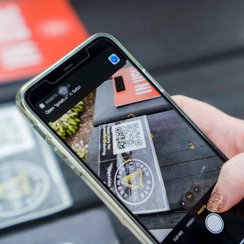 A close up photo of a phone scanning a QR code menu at a brewery