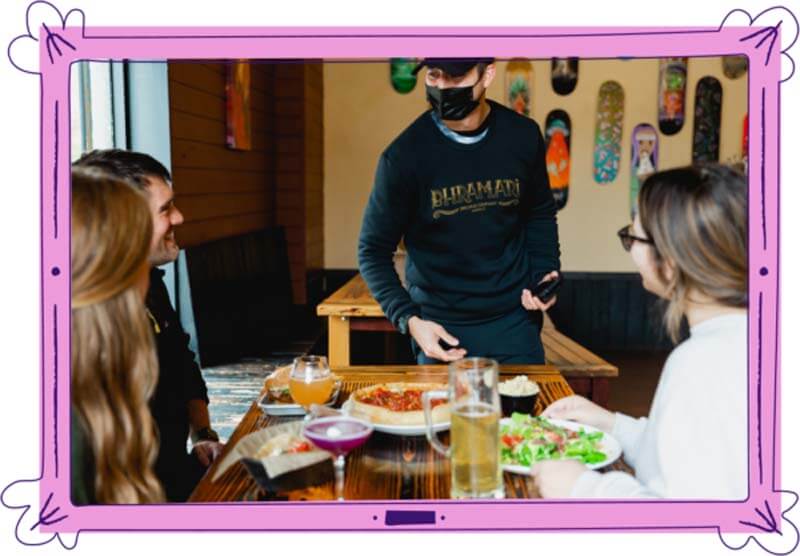 A marketing image from Arryved, a food and beverage POS system showing a group at a brewery and a server