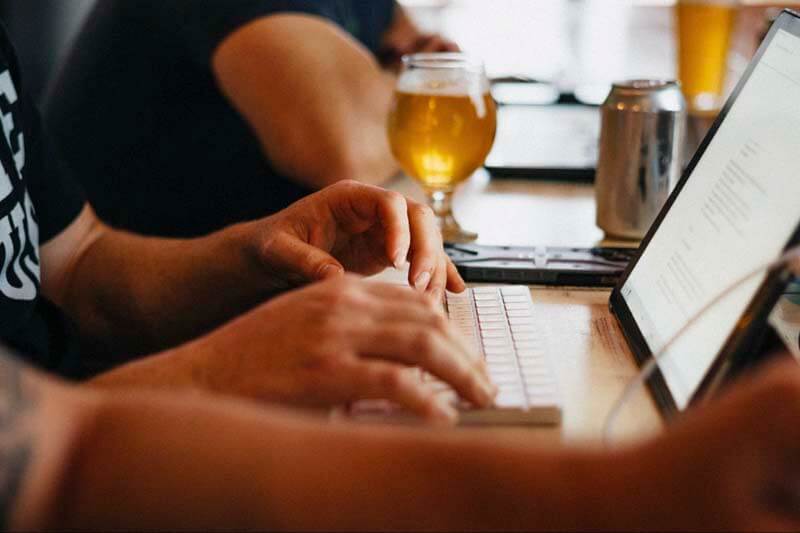 An up close photo of an accountant working with an accounting system at a craft brewery