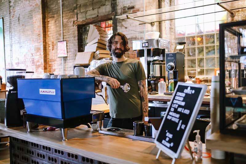 Bartender behind coffee bar at Trace Brewing craft brewery