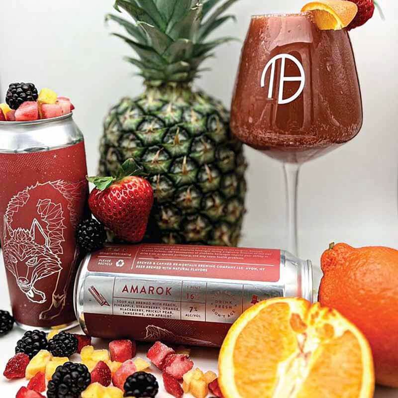 A promotional photo for Amarok fruited sour smoothie beer from Mortalis Brewing Company - showing can design among a variety of fruit ingredients