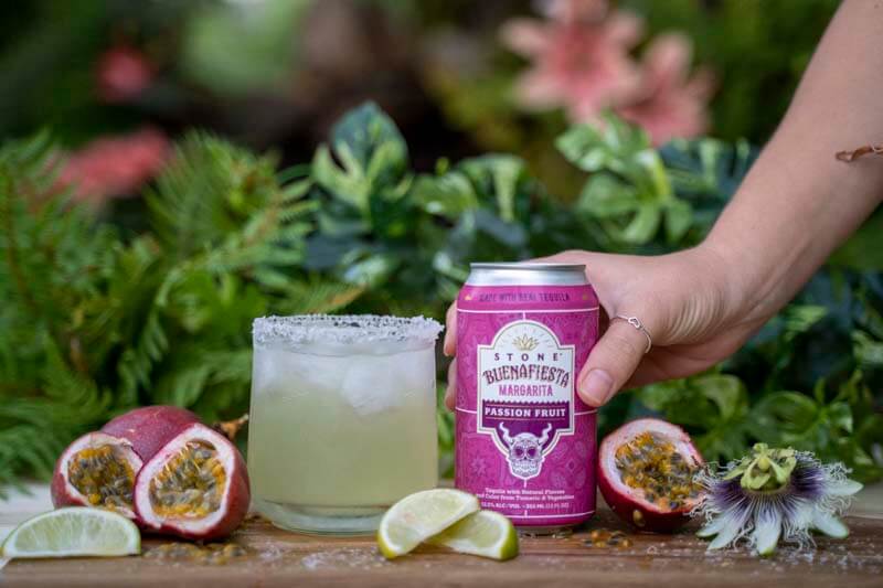 A promotional photo for Stone Brewing's Buenafiesta RTD Passion Fruit Margaritas