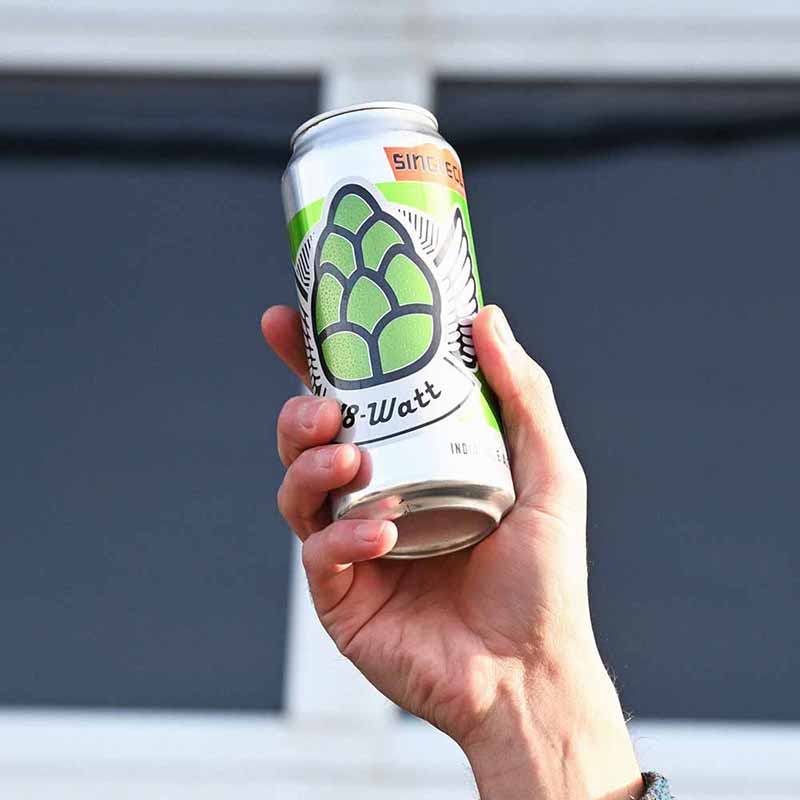 Up colse photo of a hand holding a can of 18 Watt Session IPA from Single Cut Beer