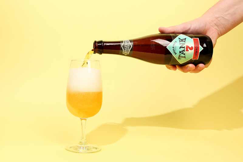 A photo of Tank 7 farmhouse ale by Boulevard Brewing being poured into a glass