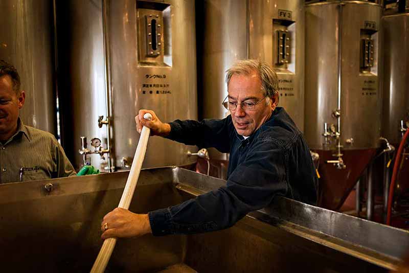 Crux Fermentation Project founder, Larry Sidor, stirring hops