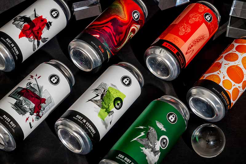A collage of Prison City Brewing craft beer cans designed by Stout Collective