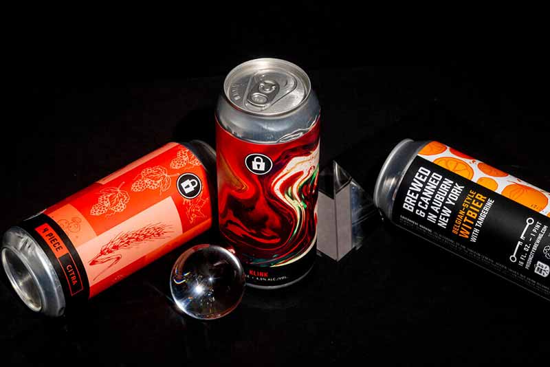 A collection of craft beer cans from Prison City Brewing designed by Stout Collective