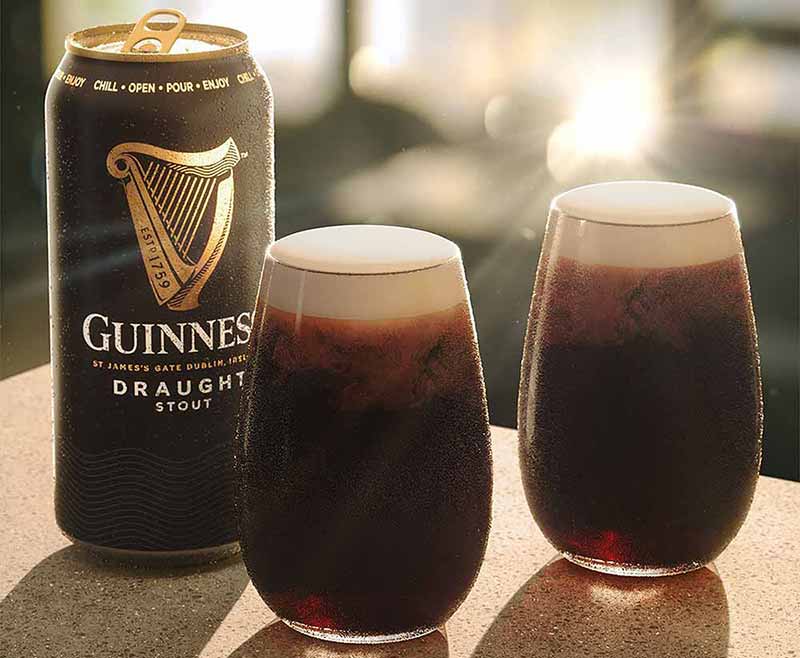 A promotional photo for Guiness Draught, a Dry Irish Stout in a can and two glasses