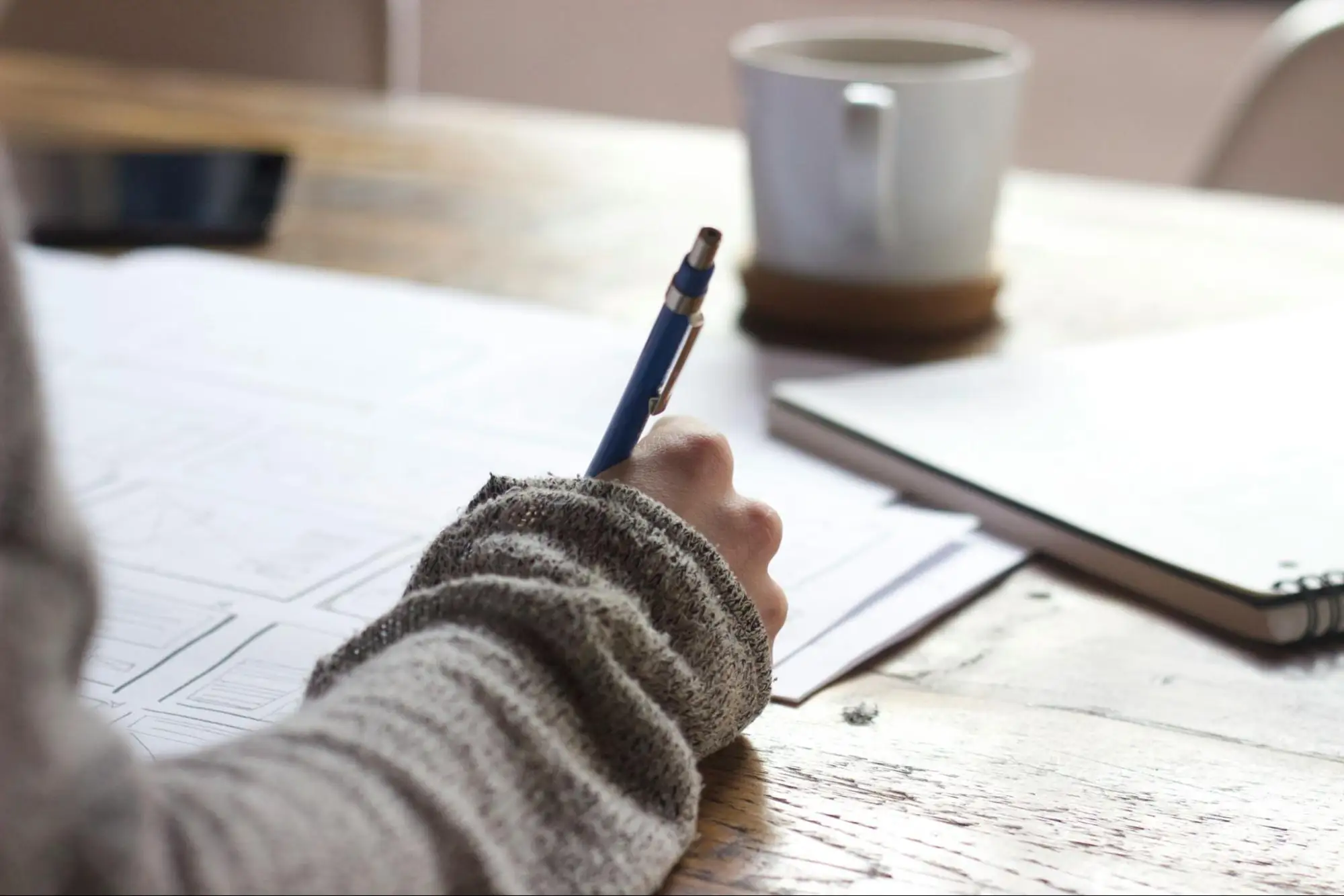 An up close photo of a hand signing legal documents