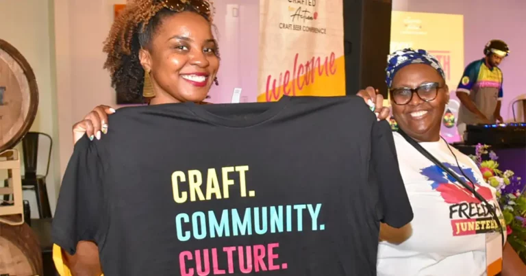 Woman holding a "Craft. Community. Culture." t shirt at Crafted For Action