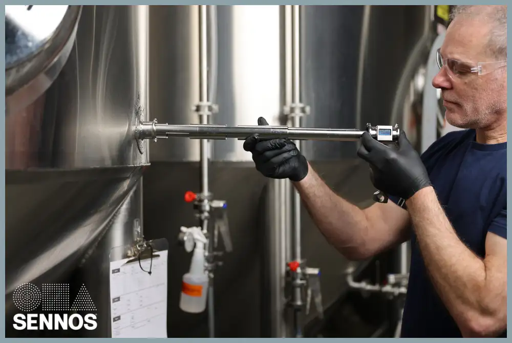 A brewer using an M3 from Sennos to check fermentation tanks